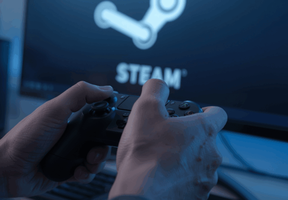 tangan gamer memegang controller di depan layar Steam